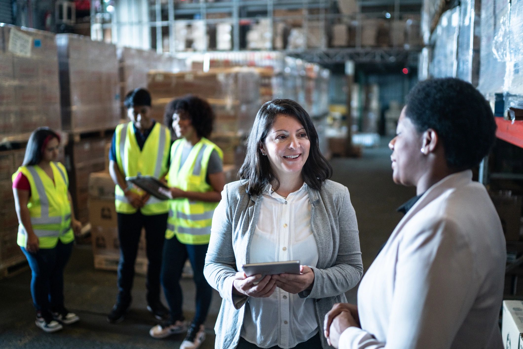 Export logistics team discussing operations in a warehouse